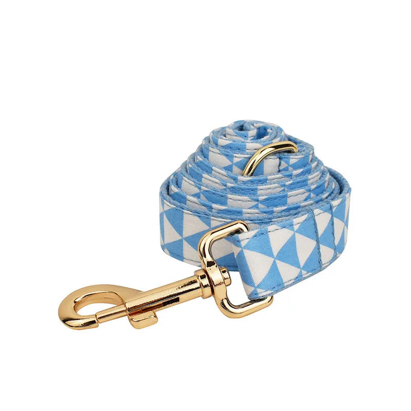 Blue four-piece dog clothing set showing vest, collar, lead and bow accessory in adjustable sizes from XS to XL