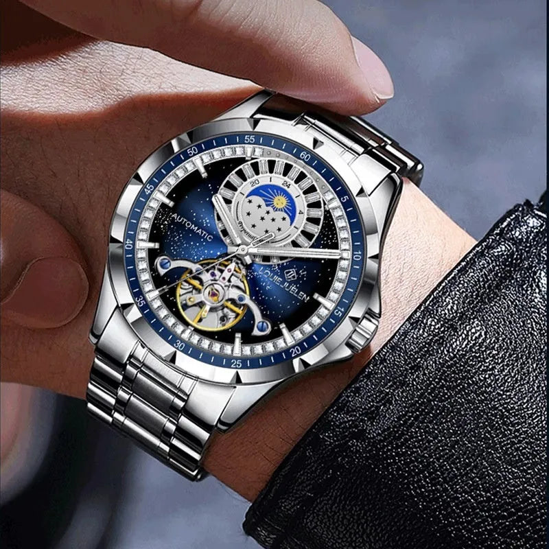 Men's silver automatic mechanical watch with blue dial on stainless steel strap showing butterfly buckle