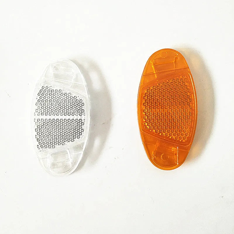 White and yellow plastic bicycle spoke reflectors for wheel safety visibility
