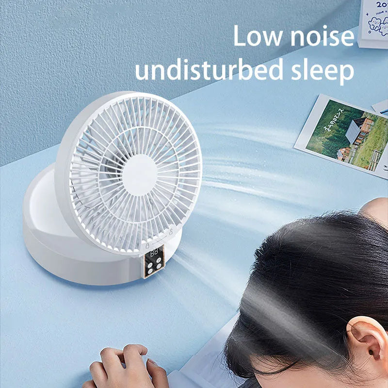 White portable rechargeable folding fan with remote control and warm night light on a desk