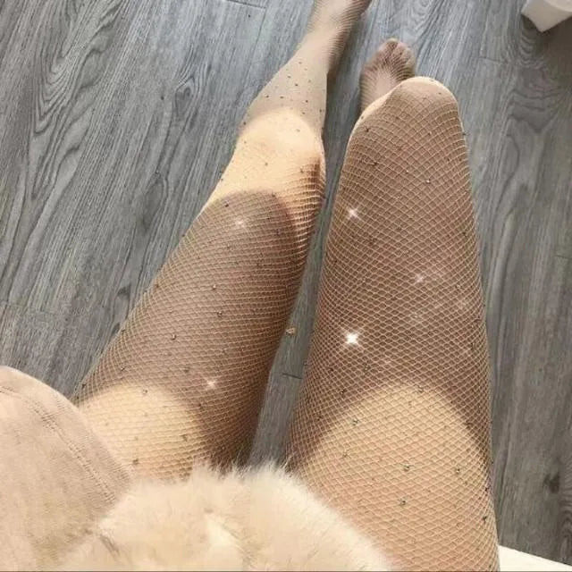 Women's fishnet stockings with diamond mesh pattern in skin colour, black, or white.