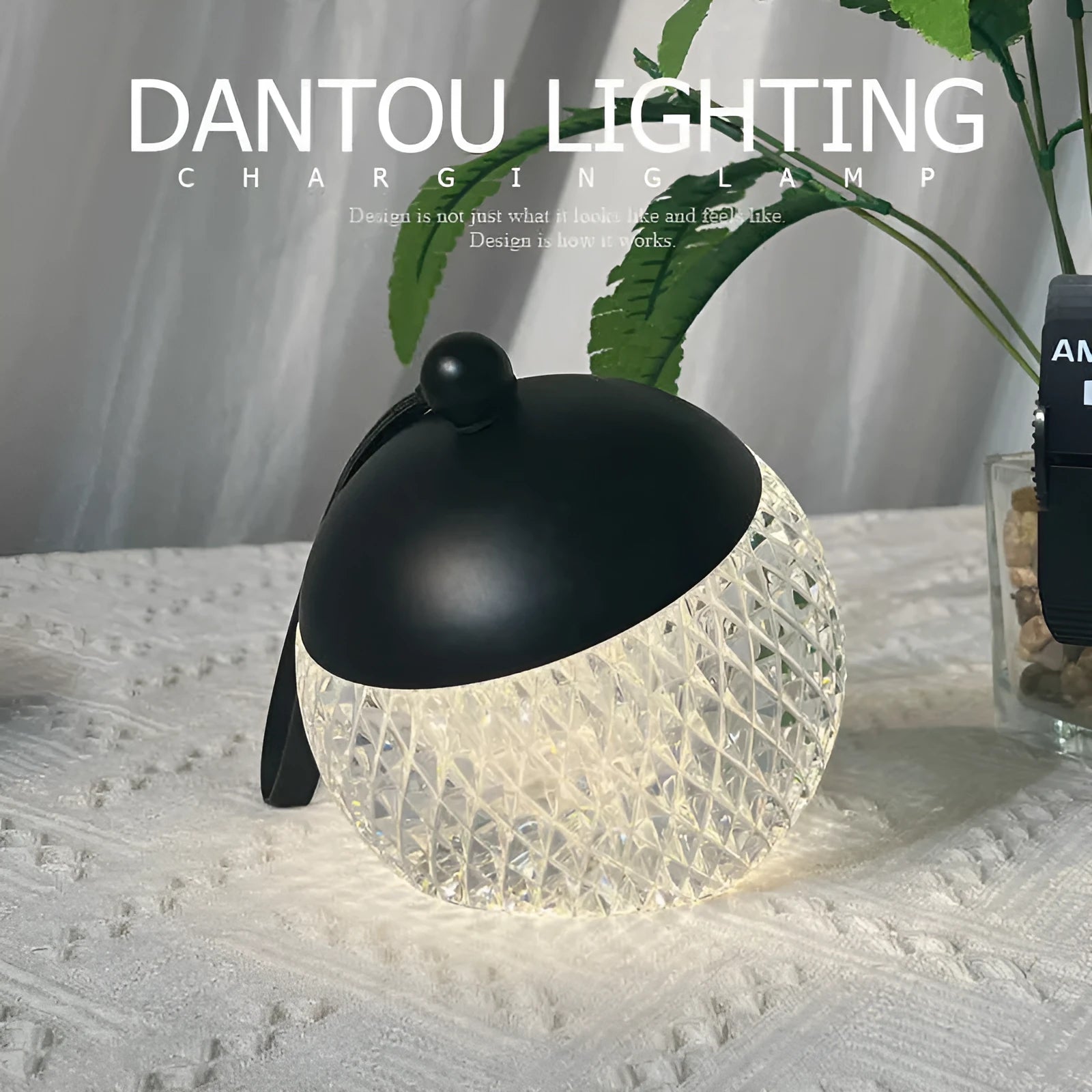 Small portable dimmable night lamp in chrome finish on wooden bedside table