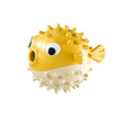 Green fish-shaped interactive dog toy with treat dispensing opening and textured surface for dental cleaning