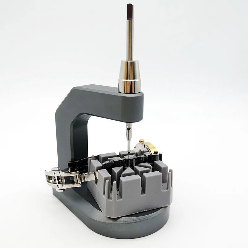 Silver multi-purpose press strap removal tool with a pointed blade for watch and jewellery repair.