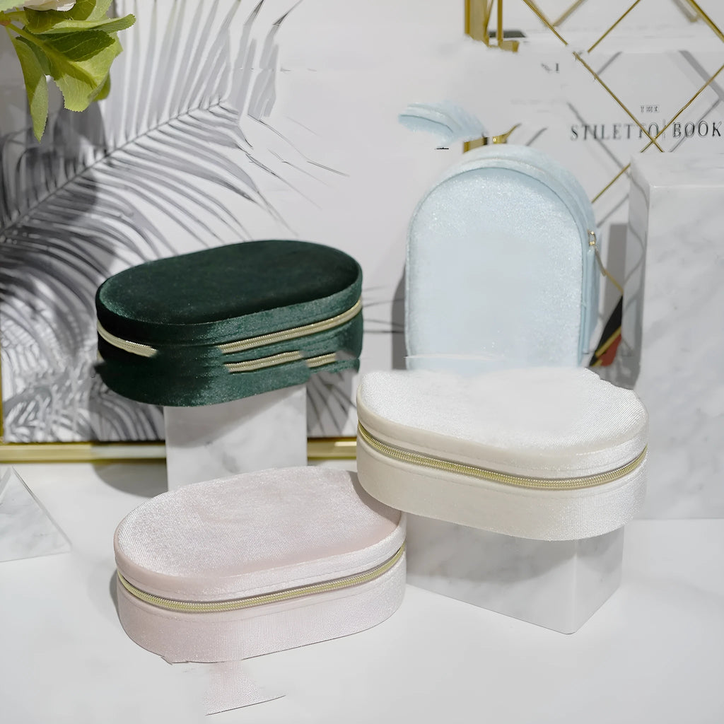 Oval velvet jewellery storage box in lake blue with flannel interior, measuring 15 by 10 cm.