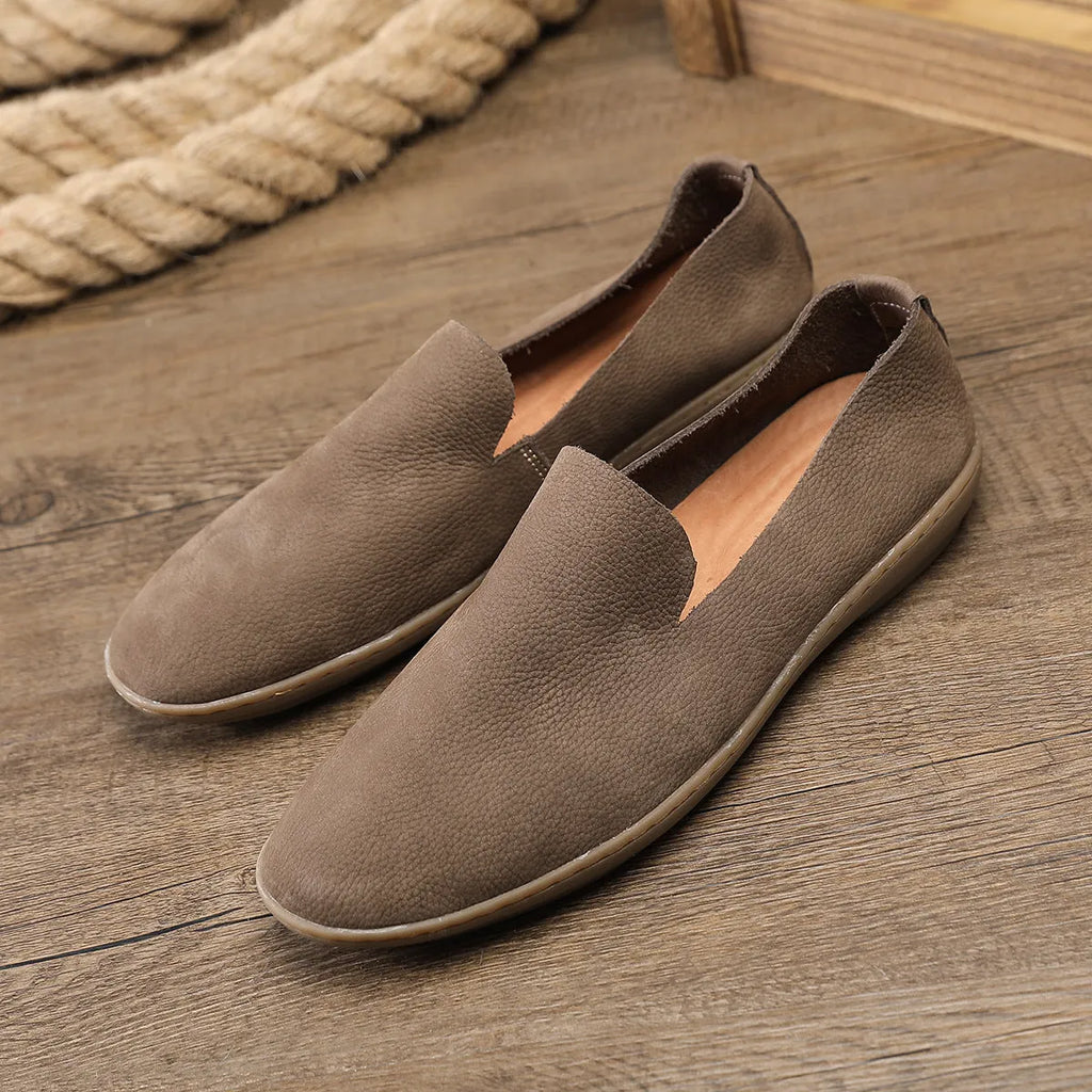 Handmade grey low-top men's casual shoes with a wedge heel and rubber sole on a white background.