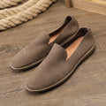 Handmade grey low-top men's casual shoes with a wedge heel and rubber sole on a white background.
