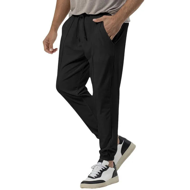 Men's grey cotton blend straight-leg track sweatpants with a tapered fit and elasticated waist.