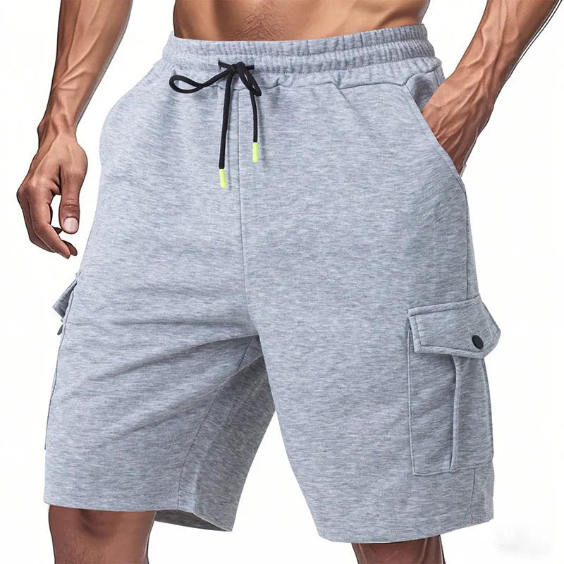 Men's loose grey terry fabric cargo shorts with multiple pockets on a hanger.