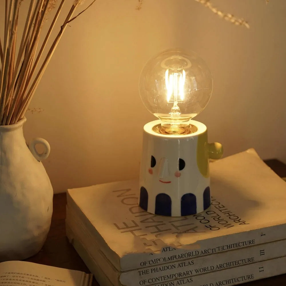 Handmade ceramic bedside lamp with ball headlight shade on wooden surface