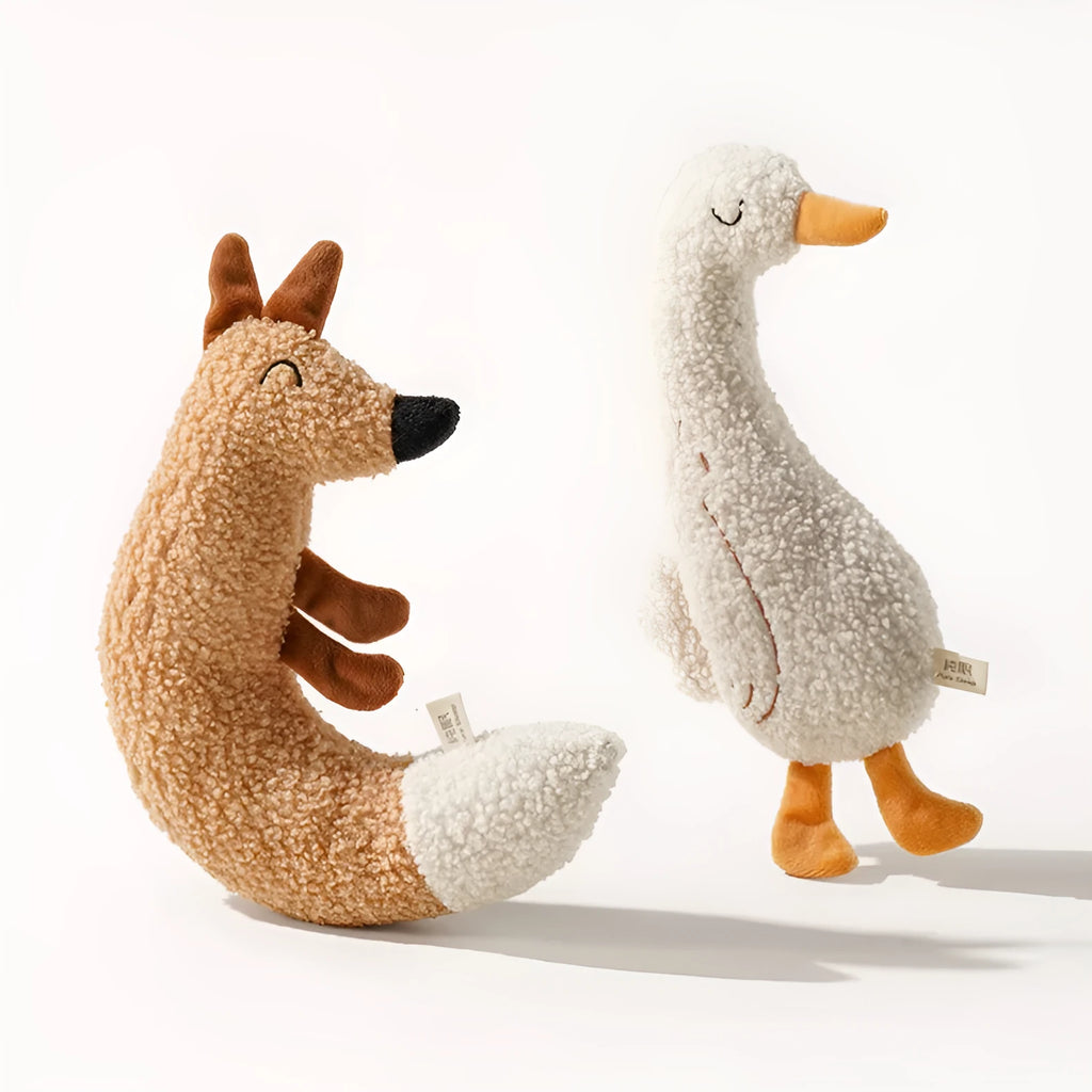 Fox and duckling cartoon plush dog toys with squeakers on a neutral background.