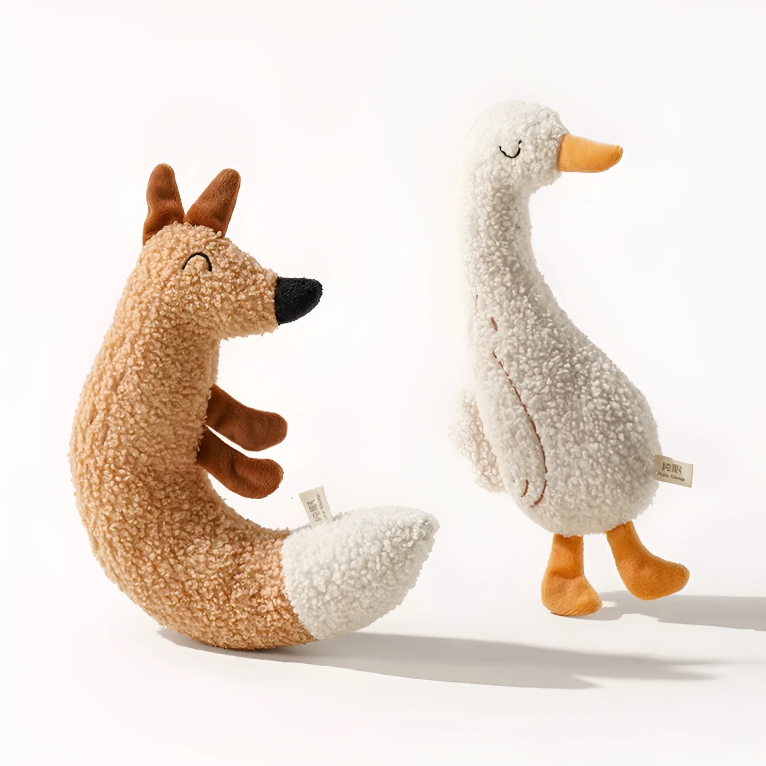 Fox and duckling cartoon plush dog toys with squeakers on a neutral background.