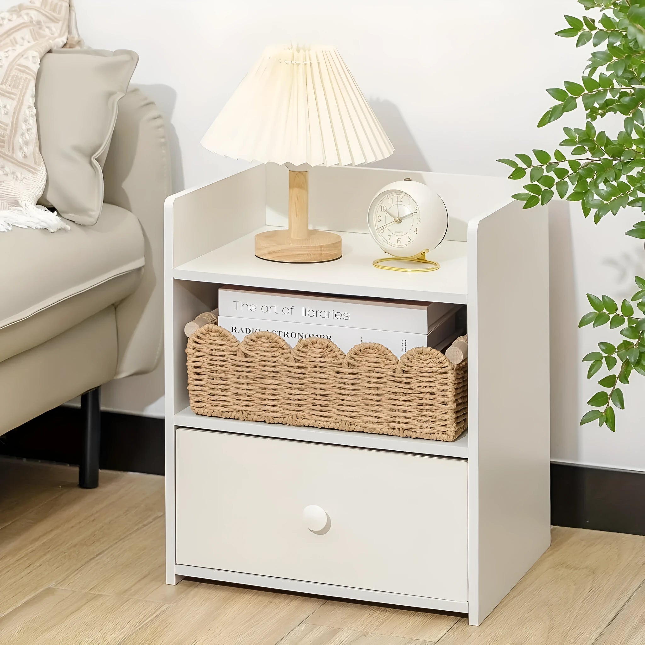 A minimalist woven paper storage basket in khaki colour on a wooden table, holding remote controls and pens.