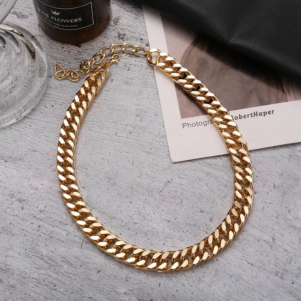 Women's gold chunky chain necklace showing thick links and pendant detail