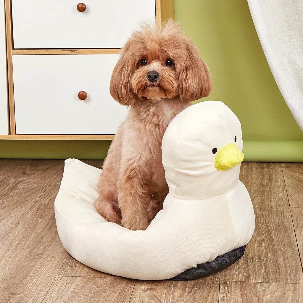Blue duck-shaped fluffy pet bed sofa for small dogs and cats on a floor.