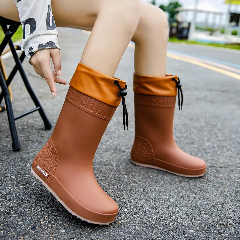 Women's solid colour PVC rain boots in apricot, shown with a non-slip sole.