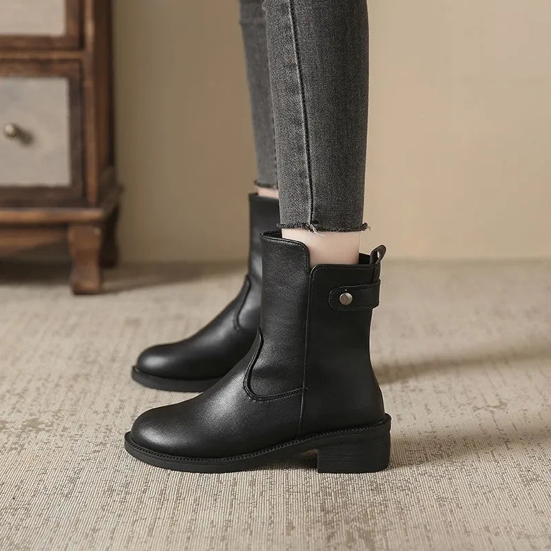 Black women's side zip boots with round toe and low rubber heel