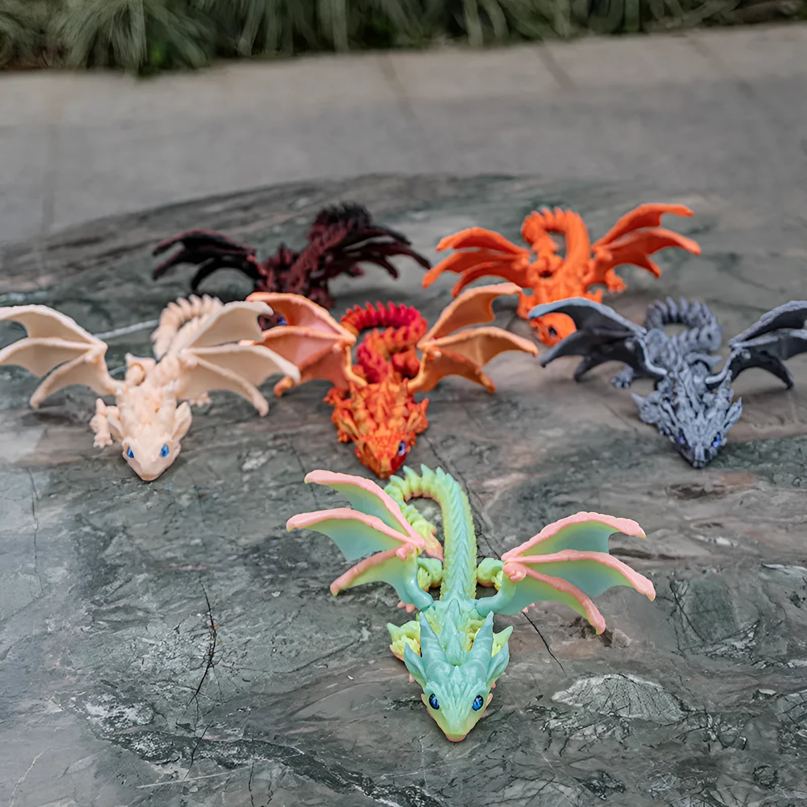 3D printed red and gold flying dragon wings decoration toy on a white background.