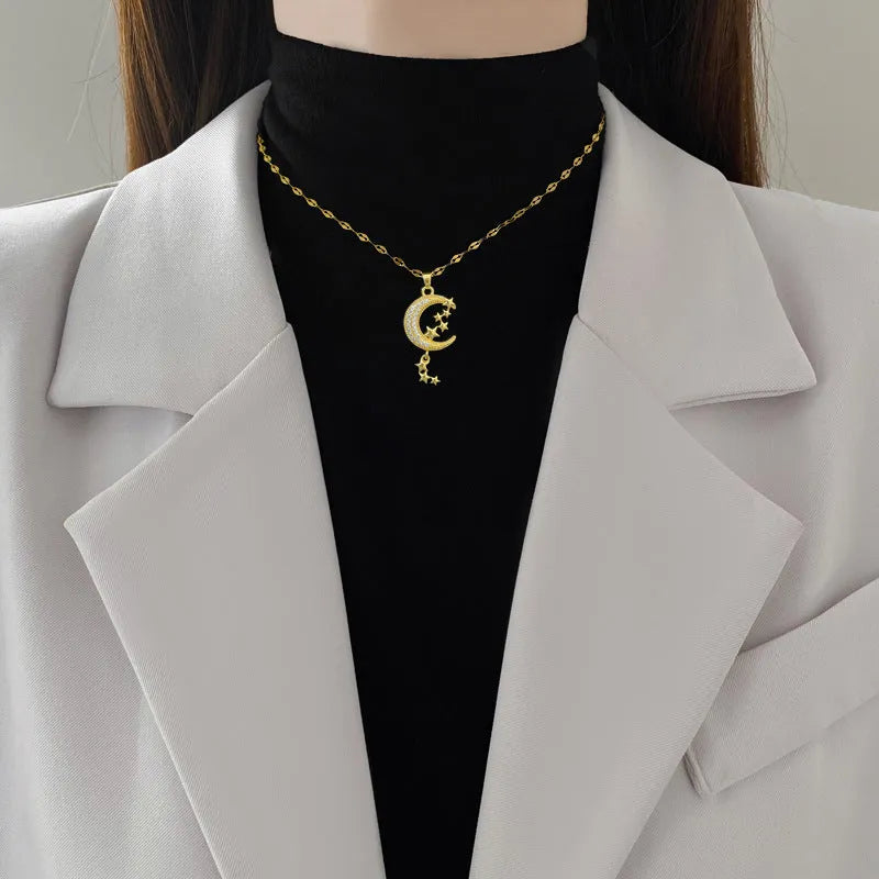 Moon and diamond tassel pendant necklace with geometric copper detail on a stainless steel chain.