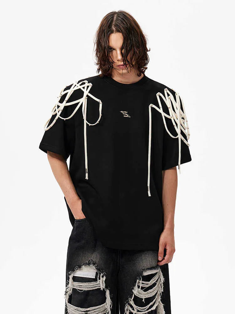 Black loose fit T-shirt with padded shoulder detail and rivet ribbon accent.