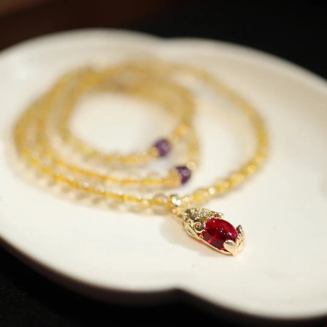 Handmade gold rutilated quartz bracelet with Chinese style design and three-circle pattern.