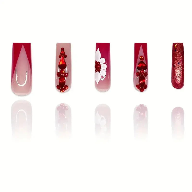 Artificial nails with red floral pattern and prismatic diamond decorations in long square shape