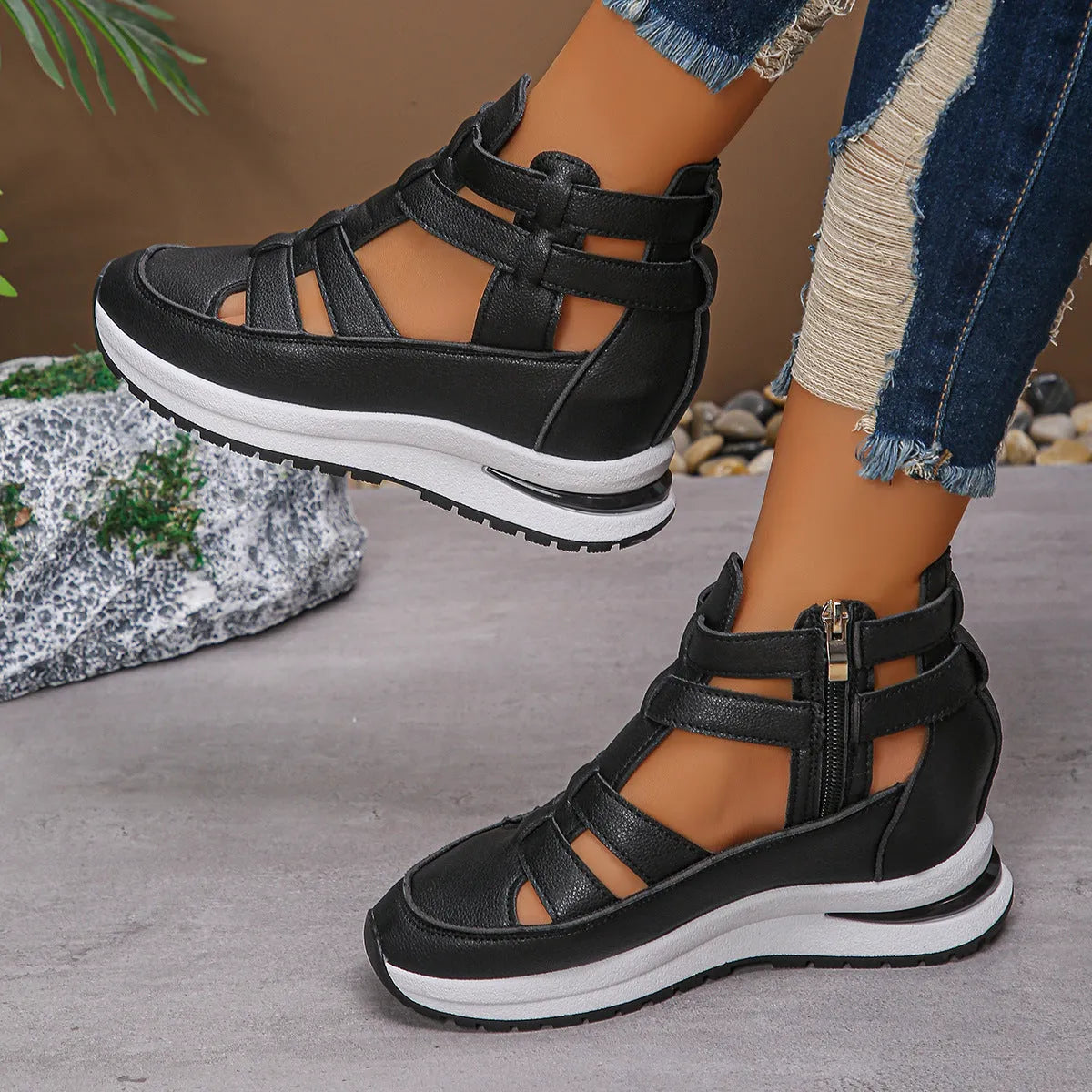 Women's black hollow-out platform sandals with Velcro fastening on a white background