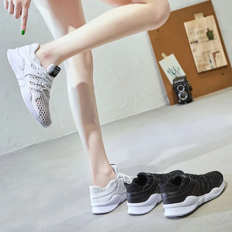 Women's low-top hollow mesh sneakers in white on a solid background.