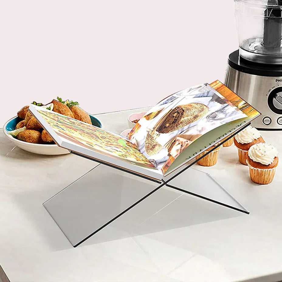 Clear acrylic X-shaped desktop book display rack holding books and magazines
