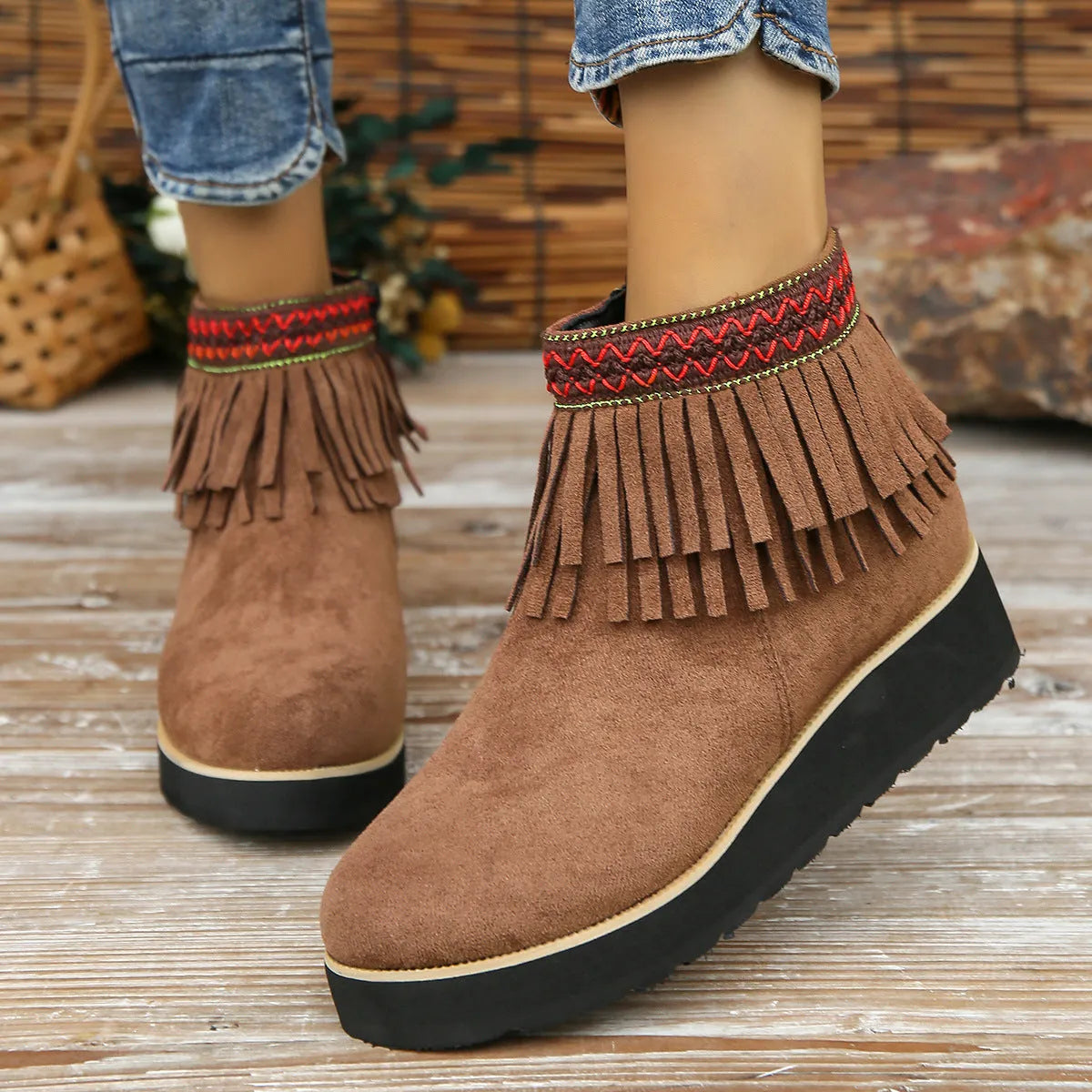 Women's dark brown suede wedge ankle boots with a side zip and decorative tassel.