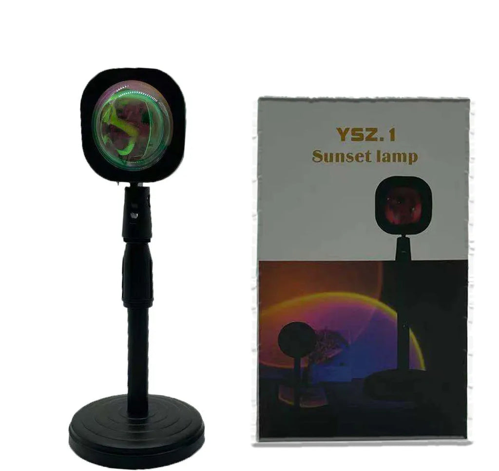 Rechargeable sunset projection lamp showing rainbow colour patterns with USB power cable