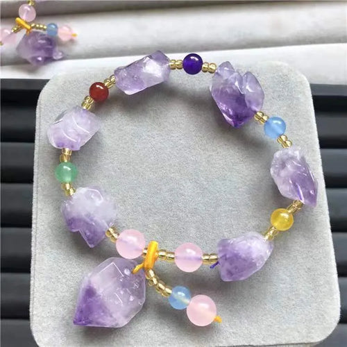 Purple natural shaped amethyst bead bracelet for women with a fu character charm.