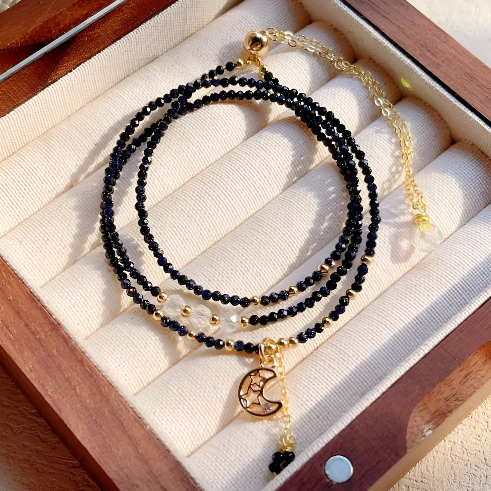 Blue sand stone three-ring multi-layer bracelet with gold-coloured metal detailing and cut stone texture