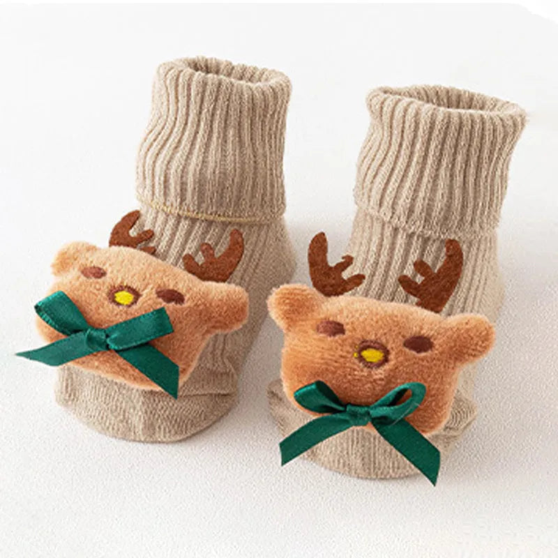 Cotton baby floor socks with non-slip soles in a pink bow print design.