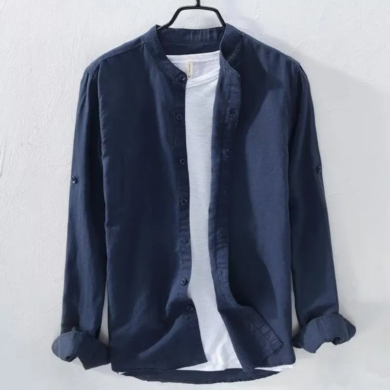 A man wearing a loose-fitting long sleeve linen casual shirt in a solid colour.