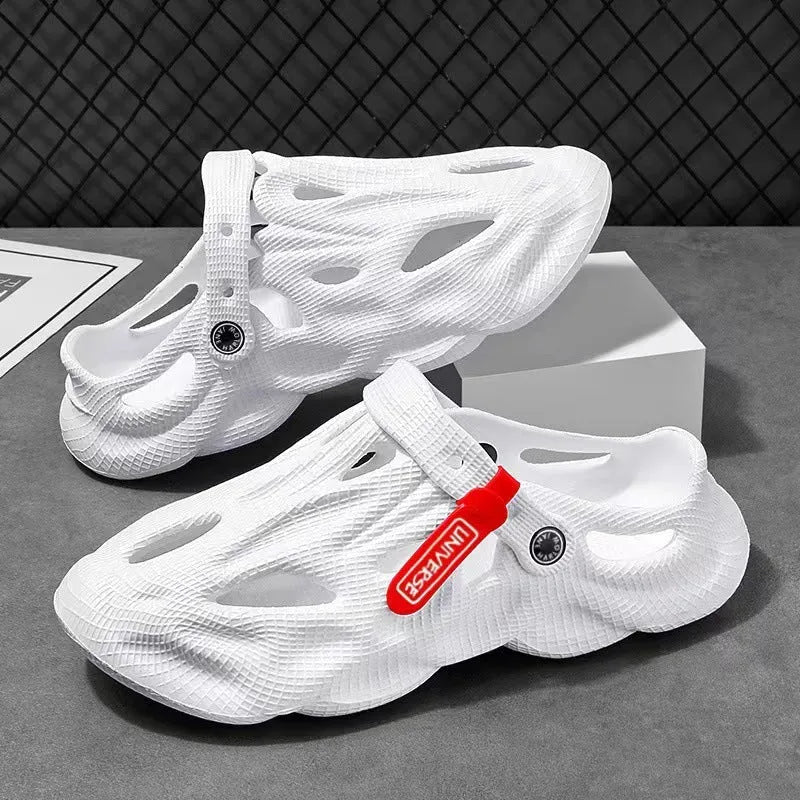 Men's grey EVA foam slippers with closed toe and thickened sole on a sandy beach.