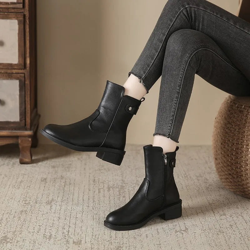 Black women's side zip boots with round toe and low rubber heel
