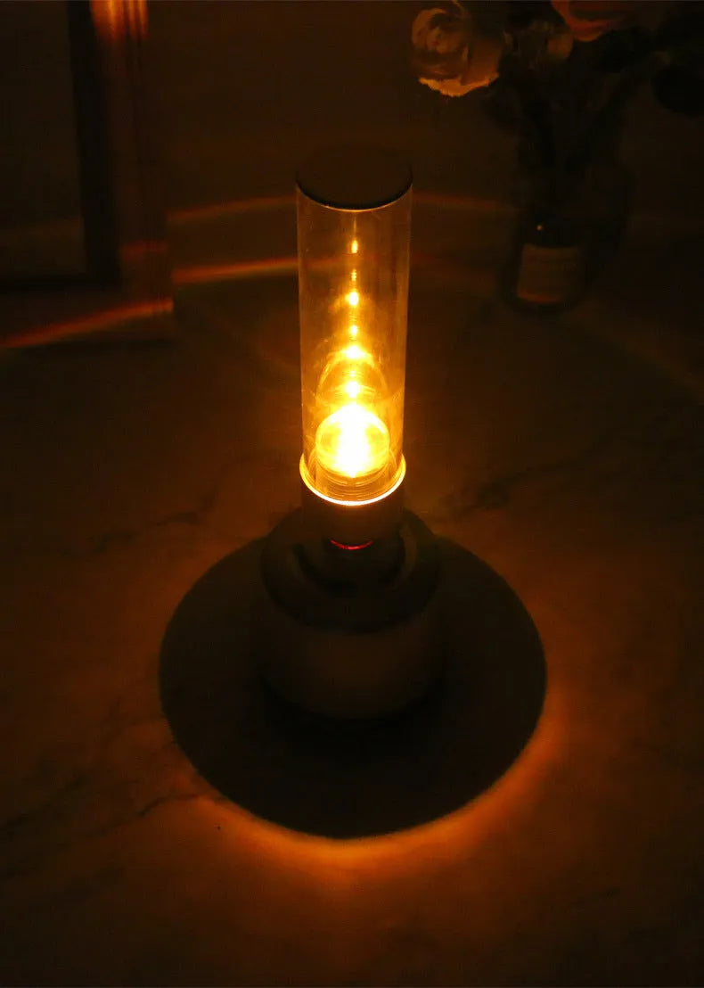 White silver candlelight Bluetooth speaker and LED atmosphere light on a table.