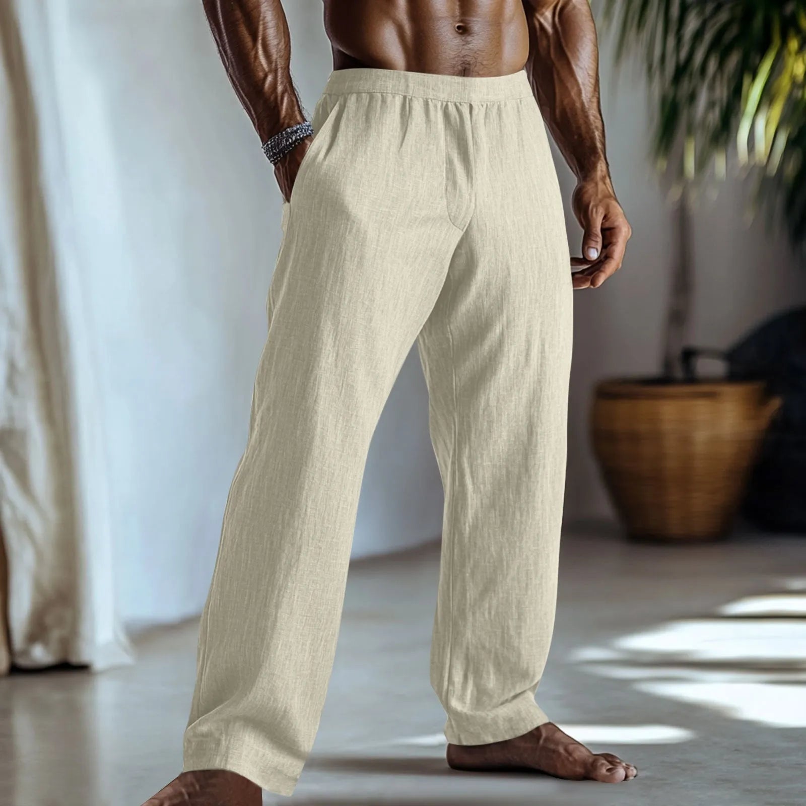 Straight leg cotton linen trousers in light apricot colour on a hanger.