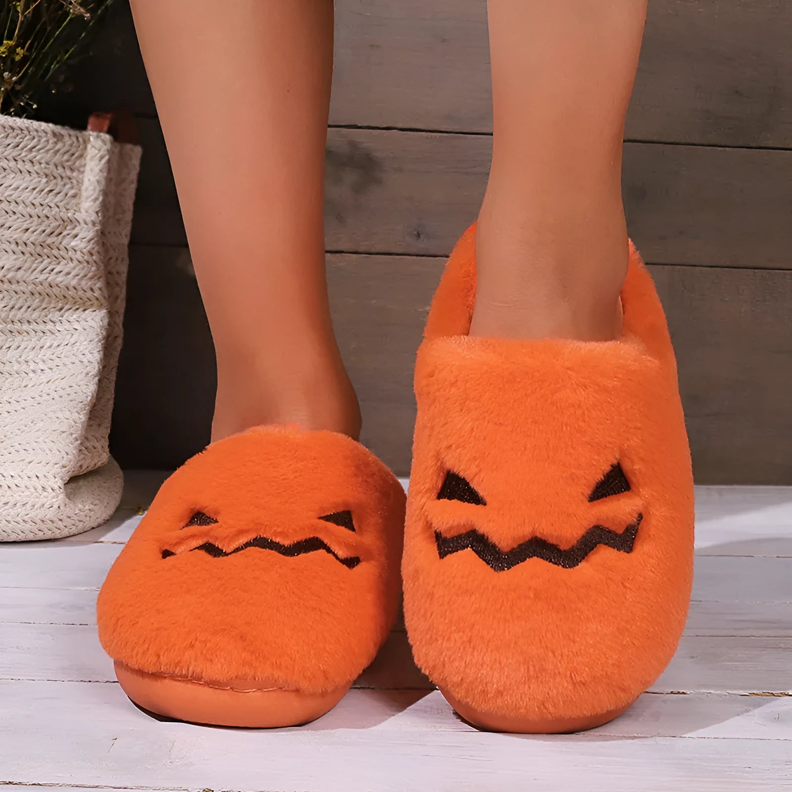 Orange coral velvet Halloween pumpkin-shaped slippers with a flat non-slip PVC sole and plush lining.