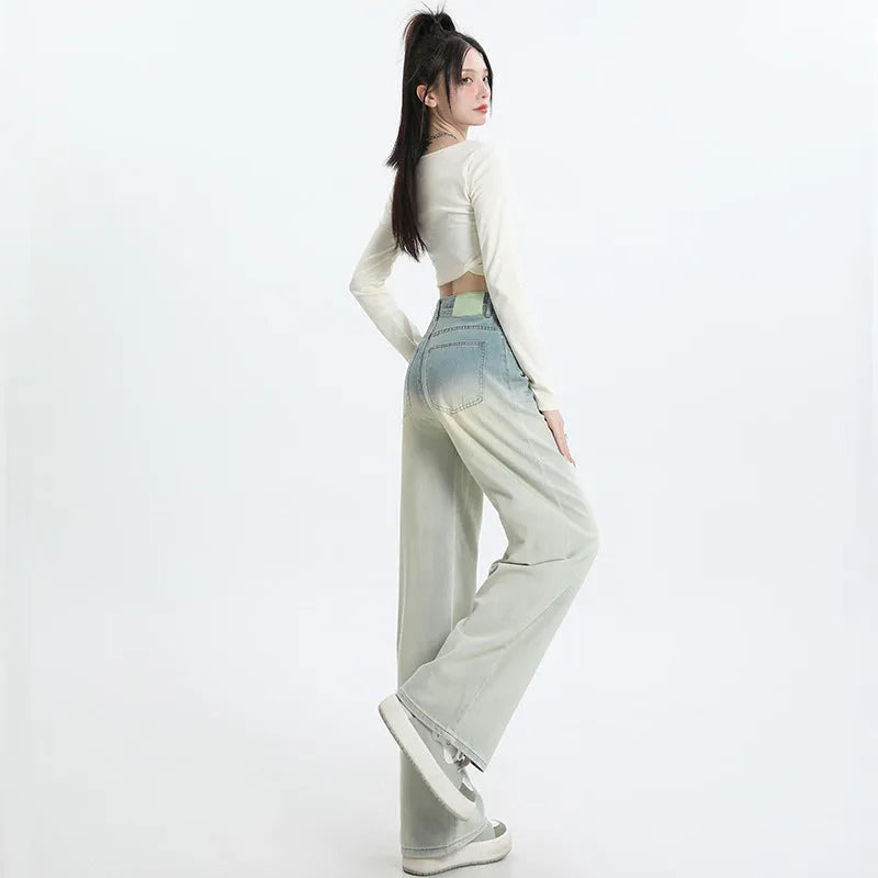 Gradient blue women's denim straight-leg trousers with a wide-leg fit on a hanger