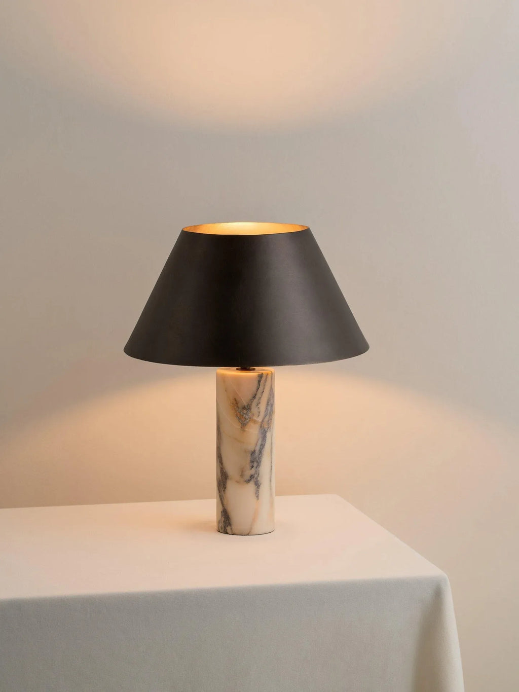Black modern marble table lamp with minimalist design on wooden surface