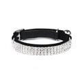 A soft red velvet cat collar with a line of rhinestones, showing the adjustable buckle.