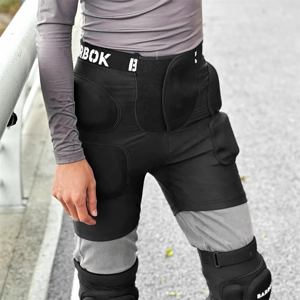 Black adult hip protection shorts with removable padding for skating and skiing safety.