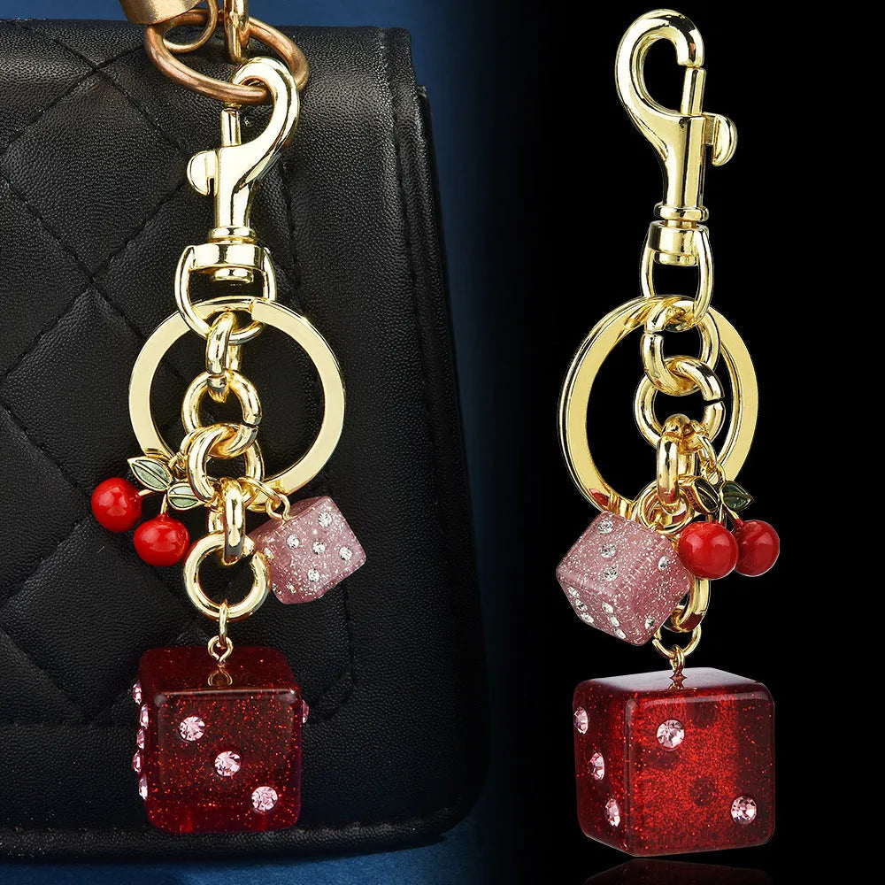 Square metal keychain pendant with a vintage cherry two-tone dice pattern for luggage or bags.