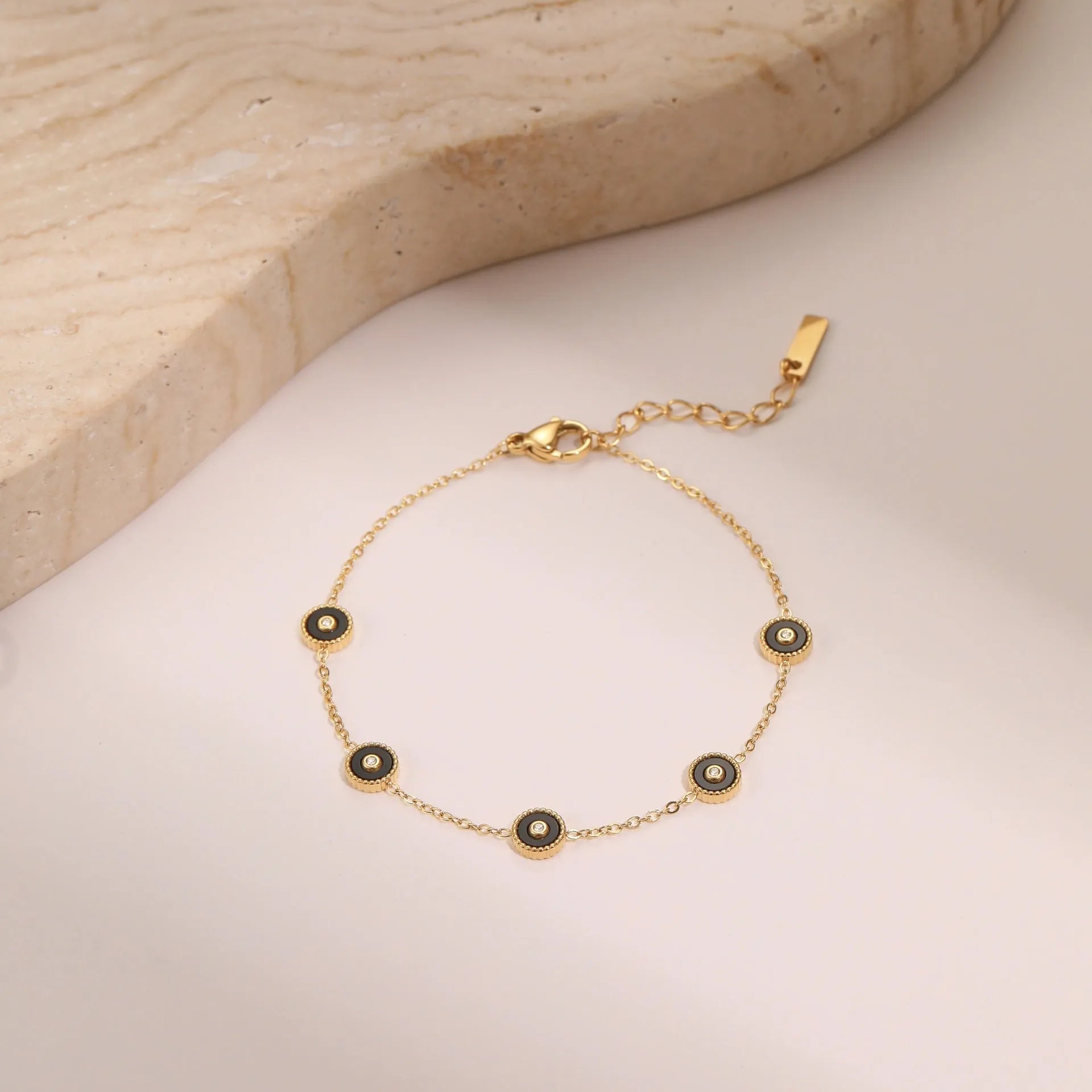 Women's stainless steel bracelet and necklace set with 18K gold plating and geometric design.