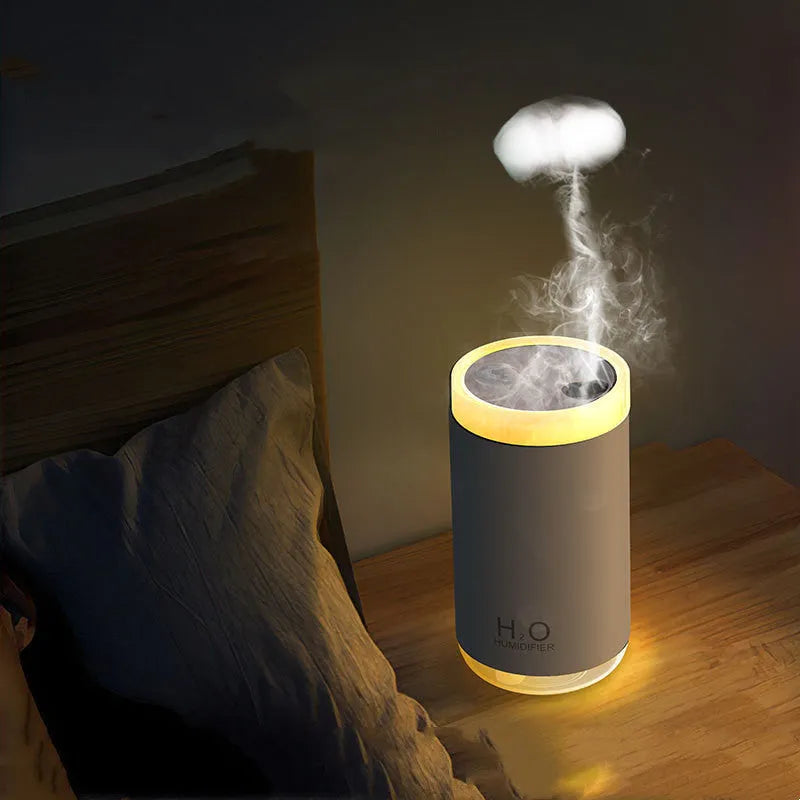 Jellyfish-shaped humidifier producing smoke ring mist with warm night light illumination