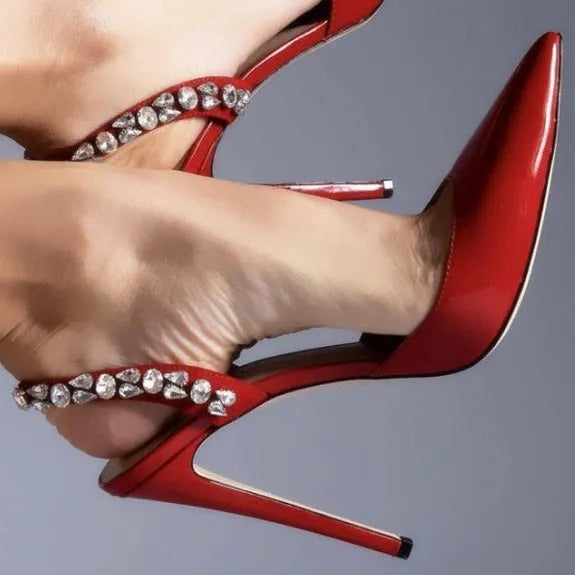 Women's black patent leather pointed toe high heel sandals with side rhinestones and an ankle strap.