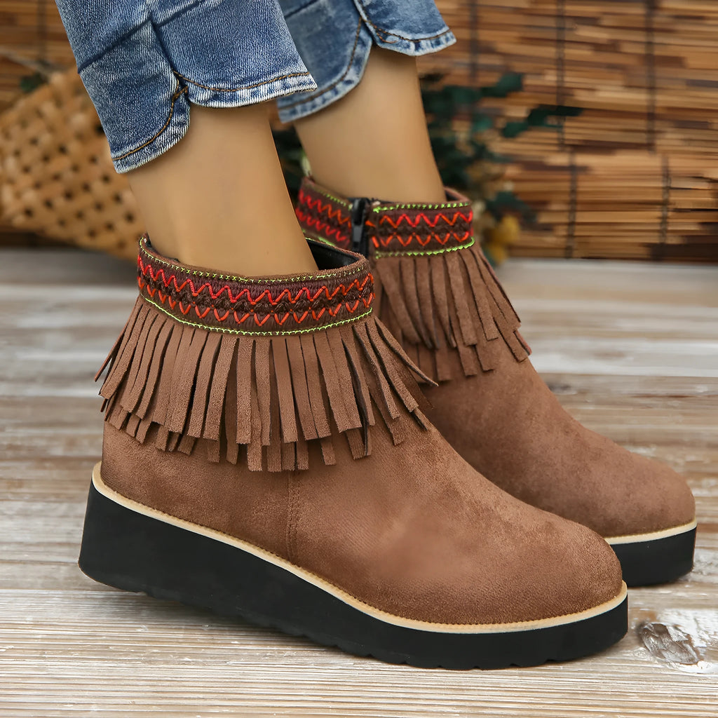 Women's dark brown suede wedge ankle boots with a side zip and decorative tassel.
