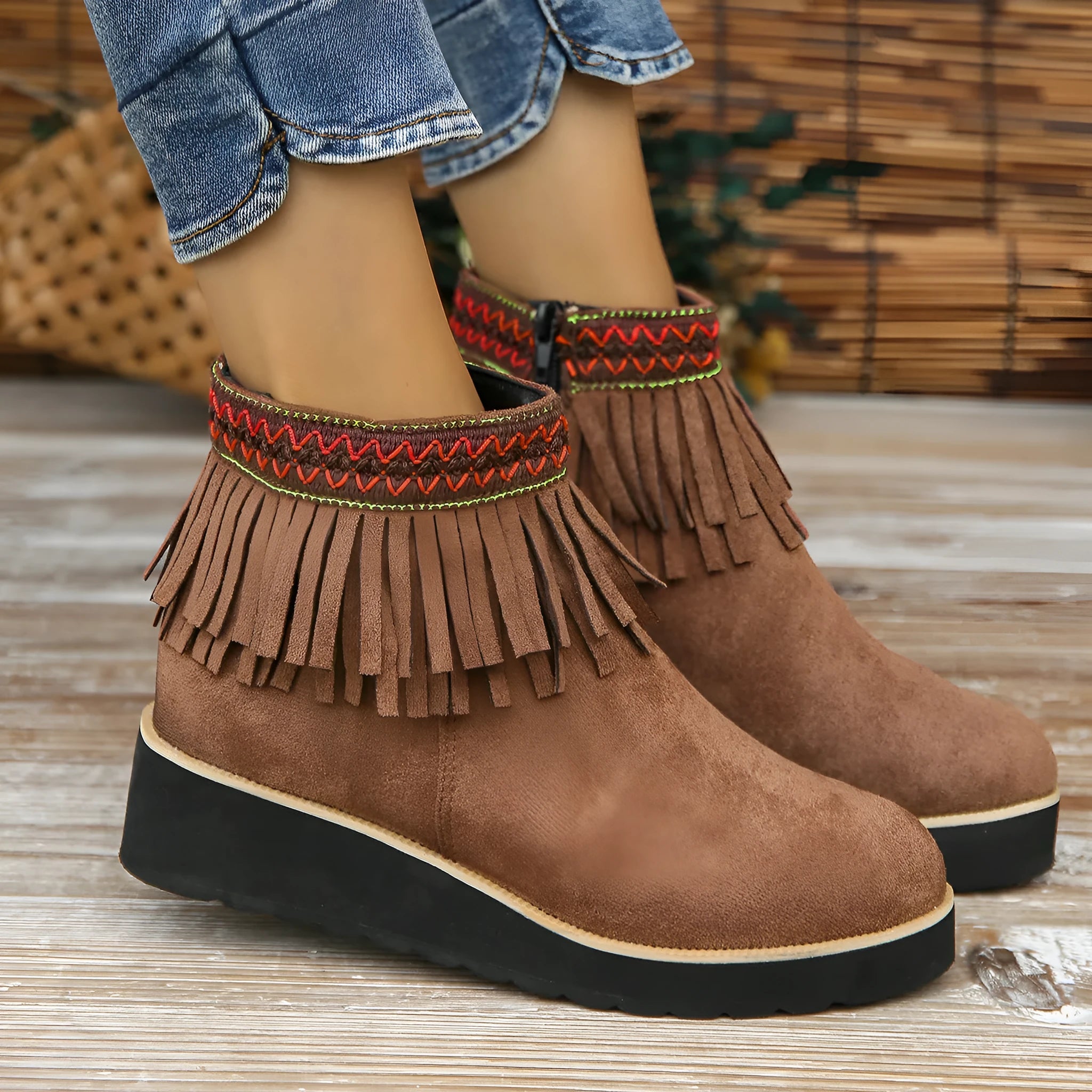 Women's dark brown suede wedge ankle boots with a side zip and decorative tassel.